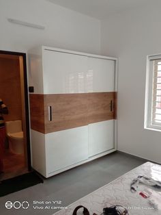 a bedroom with white and wood furniture in the middle of it's construction work