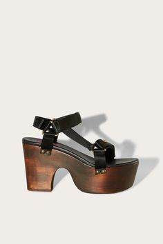 Pucci channels the bold spirit of the 70s with these wooden platform sandals. The adjustable hook and loop straps are made from smooth satin and are finished with a polished logo plaque at the front. Black, dark brown High platform wedge heel Enamelled logo plaque at front Logo leather footbed Open round toe Gold-tone metal hardware VELCRO®-fastening straps 72% viscose, 28% silk; lining: 100% leather; sole: 100% wood Made in Italy Style ID: 4HCC404HX14999 Heel height: 90mm Wooden Platform Sandals, Italy Style, Platform Wedge Heels, Retro Nostalgia, The 70s, Platform Wedge, Silk Twill, Hook And Loop, Platform Wedges