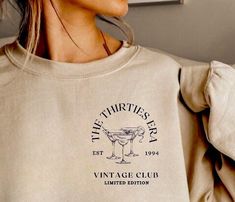 a woman wearing a sweatshirt with the words vintage club printed on it