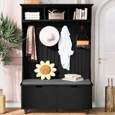 a black bench with a sunflower and hat on it in front of a white door