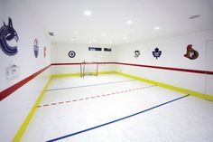 an indoor gym with white and red lines on the floor, painted in bright colors