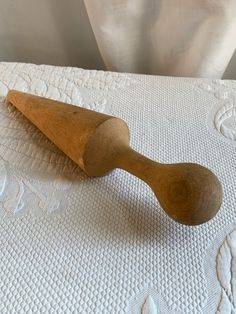 a wooden spoon sitting on top of a bed