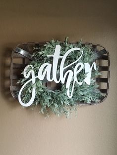 a sign that says gather hanging on the wall