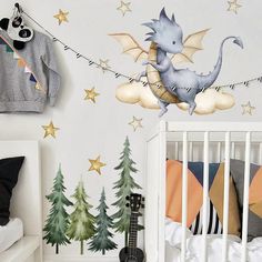 a baby's room with a crib and wall decals