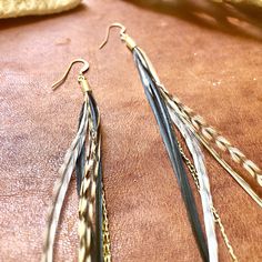 "-These delicate earrings are incredibly soft to the touch. Gold-color chains peak out between the feathers to add texture. -Coque feathers are from unique roosters that grow these exceptionally long feathers and shed them once a year. These birds have been bred for over 100 years by fly fishermen, who use the feathers as fishing lures. Sustainably sourced in the USA. -Perfect to pair with your favorite dress, jeans, or swimwear. Feathers can get wet and will be just fine. -Earwires are 14K Gold Adjustable Gold Feather Earrings, Elegant Adjustable Feather Earrings, Elegant Feather Earrings, Creepy Earrings, Black Statement Earrings, Claw Earrings, Festival Earrings, South Pasadena, Dream Catcher Earrings