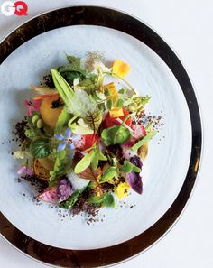 a white plate topped with lots of different types of food on top of a table