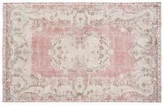 an antique rug with pink and white colors