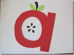 the letter q is made out of paper and has an apple on it