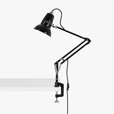 a black desk lamp on a white background