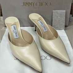 Elevate Your Shoe Game With These Stunning Jimmy Choo Rav 65mm Mules In Chalky White “Liquid” Leather. The Sleek Pointed Toe And Classic Slip-On Mule Design Make These Heels A Must Have For Any Fashion-Forward Woman. The Mid-Height Stiletto Heel Is Both Stylish And Comfortable, Perfect For A Day-To-Night Transition. These Shoes Come Brand New In Their Box With The Dust Bag, Ready To Elevate Any Outfit With Their Timeless Design. Please Review All Photos, Which Are A Part Of The Description. Happ Designer Leather Kitten Heels With Pointed Toe, Classic Open Heel Kitten Heels In Calf Leather, Luxury Kitten Heels With Heel Strap For Office, Luxury Kitten Heels With Padded Heel And Round Toe, Designer Kitten Heels With Branded Heel Counter, Luxury Slip-on Heels With Heel Strap, Luxury White Court Shoes With Deep Heel Cup, Designer Kitten Heels With Pointed Toe, Luxury White Court Shoes With Padded Heel