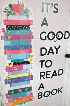 a sign that says it's a good day to read a book on the wall