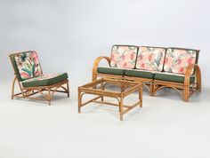 two chairs and a table with cushions on them