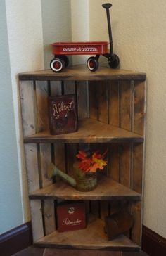 an old wooden shelf with various items on it and a toy truck sitting on top