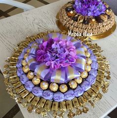 two cakes decorated with purple and gold decorations