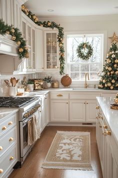 a white kitchen decorated for christmas with wreaths and garland on the window sill