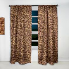 a leopard print curtain hanging in front of a window