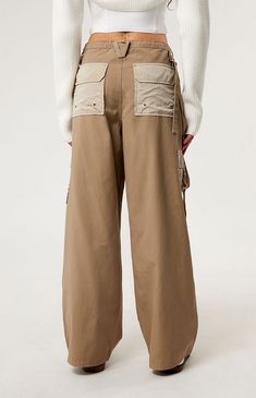 Level up your streetwear style with the PacSun Brown Toggle Baggy Cargo Pants. These on-trend mid-rise pants combine edgy style with comfort, featuring a baggy fit, cargo pockets, and an adjustable toggle waist for a customizable fit. Trendy Streetwear Parachute Pants With Patch Pockets, Trendy Parachute Pants With Patch Pockets For Streetwear, Wide-leg Parachute Pants With Belt Loops For Streetwear, Hip Hop Style Wide Leg Khaki Bottoms, Urban Baggy Straight Leg Parachute Pants, Streetwear Wide Leg Cargo Pants, Baggy Straight Leg Urban Parachute Pants, Urban Baggy Wide Leg Pants For Streetwear, Wide Leg Cargo Jeans For Outdoor Fall Activities