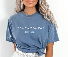 This Mama shirt with kids' names is perfect for any mama who wears her heart on her sleeve. Makes a great Mother's Day Gift for a new mom or new Grandma! Customize with any saying, (Mom, Gigi, Nana Etc.) and est. year. Customize with kids' names on sleeve. Featured on a short sleeve Comfort Color tee. ✨ HOW TO ORDER ✨ ✧ Select Options from the Drop Downs ✧ Record personalization requests ✧ ADD TO CART 🎨 GRAPHIC DETAILS 🎨 ► Professionally and Permanently Printing Process ► Vibrant and Accurate Casual Personalized Short Sleeve Shirt, Custom Name Cotton Top As A Gift, Custom Name Tops For Mother's Day Gift, Customizable Blue Tops For Family Occasions, Casual Personalized Short Sleeve Tops, Custom Name Short Sleeve Tops For Gifts, Mother's Day Blue Crew Neck Shirt, Personalized Casual Short Sleeve Tops, Custom Name Short Sleeve Tops For Gift