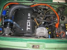 the engine compartment of a green car