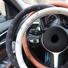 the steering wheel cover is decorated with black, white and orange embellishments