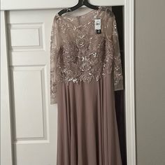 a dress hanging on a hanger in front of a door