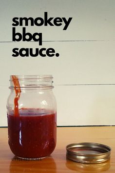 a jar filled with liquid sitting on top of a wooden table