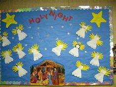 a bulletin board with the nativity scene on it's side and stars in the sky