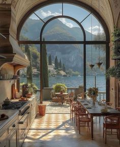 a large kitchen with an arched window overlooking the lake and mountains is pictured in this image