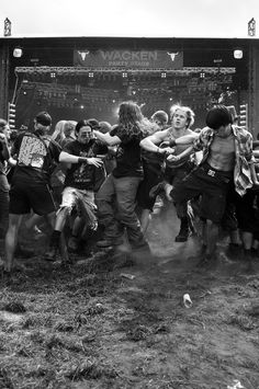 a group of people standing around each other in front of a stage