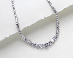 Beautiful rose gold cubic zirconia bridal tennis necklace created with Round cubic zirconia in a graduated style. This is classic style that will match any wedding gown or special occasion dress - PLEASE ALLOW APPROX 3-5 BUSINESS DAYS FOR COMPLETION BEFORE SHIPPING.- Handcrafted with Premium cubic zirconia stones - All clear stones- Rhodium, yellow gold or rose gold finish- Necklace measures 16.5 inches and extends to 18.5 inches- Nickel free and hypoallergenic This is an original design by © Treasures by Agnes FOR MATCHING PIECES SIMPLY TYPE "SOPHIE" IN THE SEARCH BAR Elegant Cubic Zirconia Tennis Necklace For Wedding, White Gold Tennis Necklace With Sparkling Stones For Wedding, White Gold Sparkling Stones Tennis Necklace For Wedding, Wedding Tennis Necklace With Brilliant Cut Cubic Zirconia, Brilliant Cut Cubic Zirconia Tennis Necklace For Wedding, Wedding White Gold Tennis Necklace With Cubic Zirconia, Sparkling Stone Round Cut Tennis Necklace For Wedding, Sparkling Stones Tennis Necklace For Wedding, Wedding Tennis Necklace With Brilliant Round Cut