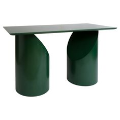 a green table sitting on top of a white floor