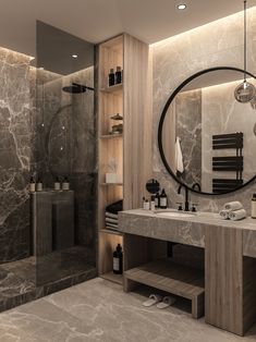 a bathroom with marble walls and flooring has a large round mirror above the sink