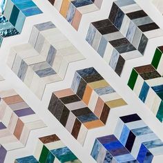 many different colored tiles are arranged in the shape of hexagons and rectangles