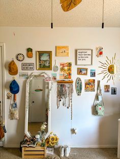 there is a mirror and many pictures on the wall in this room with sunflowers