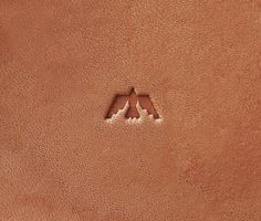 an animal's paw is seen in the sand on top of a brown surface