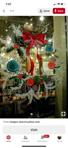 an image of a christmas window display with ornaments in the front and on the back