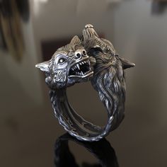 Introducing our striking handcrafted 925 Sterling Silver Two Wolf Head Ring, a captivating accessory inspired by the majestic and powerful nature of wolves. This unique ring features an intricate design of two wolf heads facing each other, crafted from high-quality, solid 925 sterling silver to ensure durability and longevity. Our Two Wolf Head Ring is a unisex accessory, making it a perfect choice for both men and women who appreciate the symbolism and beauty of these magnificent animals. Its c Wolf Ring Art, Symbolic Hand Forged Ring Jewelry, Fantasy Style Silver Jewelry With Unique Design, Symbolic Hand Cast Ring Jewelry, Handmade Silver Fantasy Jewelry, Handmade Fantasy Silver Jewelry, Fantasy Style Oxidized Jewelry As A Gift, Fantasy Oxidized Finish Jewelry As A Gift, Fantasy Style Oxidized Jewelry Gift