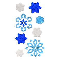 blue and white snowflakes are arranged on a white surface, including one in the middle