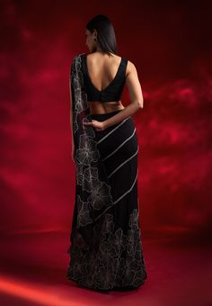 Embrace elegance with this black sari, showcasing large flower embroidery and intricate 3D flower work on the palla. The ensemble is completed with an embellished blouse, offering a perfect blend of dramatic floral details and luxurious craftsmanship for a stunning and sophisticated look. Large Flower Embroidery, Organza Sari, Black Sari, Floral Cutwork, Saree Organza, Draped Saree, Drape Saree, Cutwork Embroidery, Black Saree