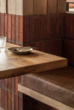 a wooden table with a plate and glass on it