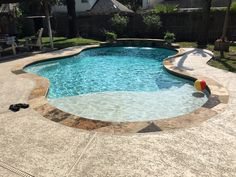 an empty swimming pool in the middle of a backyard