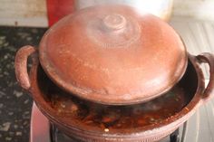 an old pot sitting on top of a stove