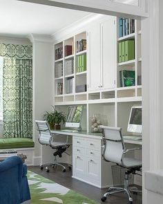 a living room filled with furniture and bookshelves next to a green rug on top of a hard wood floor