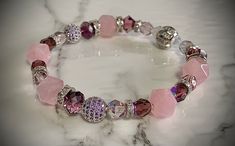 Purple lovers!  Mix of purple and pink fine gem stones.  Showing it with  Swarovski purple charm bracelet for stacking.  Separate purchase. Pink Faceted Beaded Bracelet As A Gift, Pink Faceted Beaded Bracelets As A Gift, Elegant Pink Amethyst Crystal Bracelet, Pink Faceted Crystal Bracelet Gift, Pink Faceted Crystal Bracelet For Gift, Pink Amethyst Round Beads Jewelry, Pink Amethyst Bead Jewelry, Pink Amethyst Jewelry With Round Beads, Pink Amethyst Beaded Bracelets For Gift