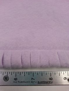 a ruler is next to a purple blanket