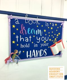 a book is a dream that you hold in your hands on a blue sign hanging from the wall