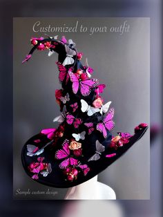 a black hat with pink and white butterflies on it