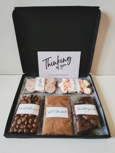 a box filled with assorted chocolates and candies on top of a table