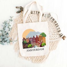 Amsterdam Canvas Tote Bag Introducing the Amsterdam Canvas Tote Bag - a perfect blend of style, durability, and functionality. Crafted from high-quality canvas material, this tote bag is designed to be your go-to accessory for any occasion. Whether you're heading to the farmer's market, the beach, or a casual day out with friends, the Amsterdam Canvas Tote Bag offers ample space and robust strength to carry all your essentials with ease. Choose between two sizes: 12x14 inch 14x16 inch Print on f Tote Bags For Weekend Trips, Tote Gift Bag For Weekend Trips, White Tote Shoulder Bag For Weekend Trips, Travel Tote Gift Bag, Travel Pouch Canvas Gift Bag, Eco-friendly Canvas Shoulder Bag For Travel, Handmade Rectangular Canvas Travel Bag, Eco-friendly Rectangular Canvas Travel Bag, Beige Tote Shoulder Bag For Weekend Trips