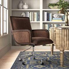 a brown office chair sitting on top of a blue rug in front of a book shelf